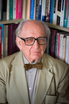 Herbert C. Kelman with bookshelf